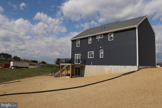 exterior space with a wooden deck and a lawn