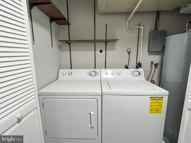 clothes washing area featuring water heater, washer and dryer, and hookup for a washing machine