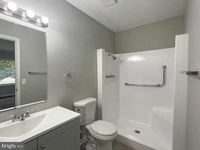 bathroom with a shower, toilet, and vanity