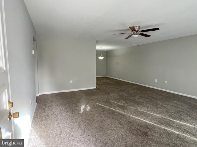 carpeted empty room featuring ceiling fan