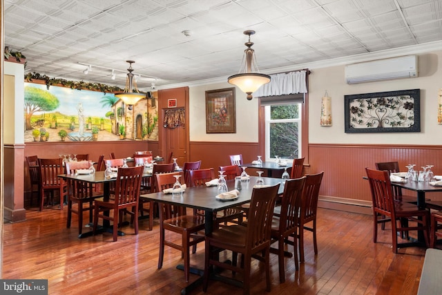 dining room with an AC wall unit, crown molding, and dark hardwood / wood-style floors