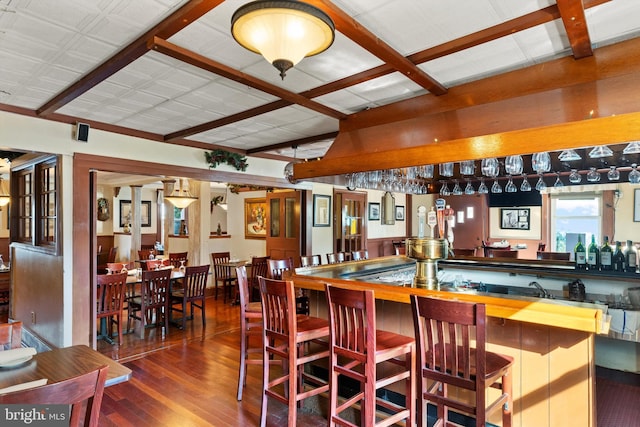 interior space with dark hardwood / wood-style flooring and a kitchen breakfast bar