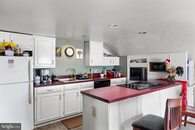 kitchen featuring a breakfast bar, sink, white cabinetry, and black appliances