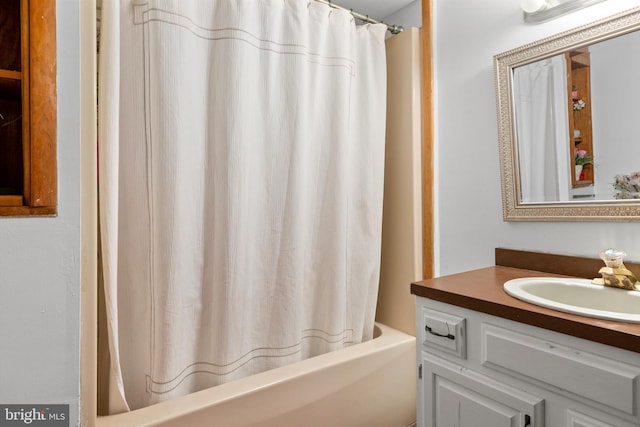 bathroom with vanity and shower / bathtub combination with curtain