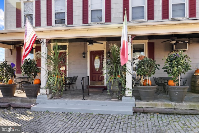 property entrance featuring covered porch and ceiling fan