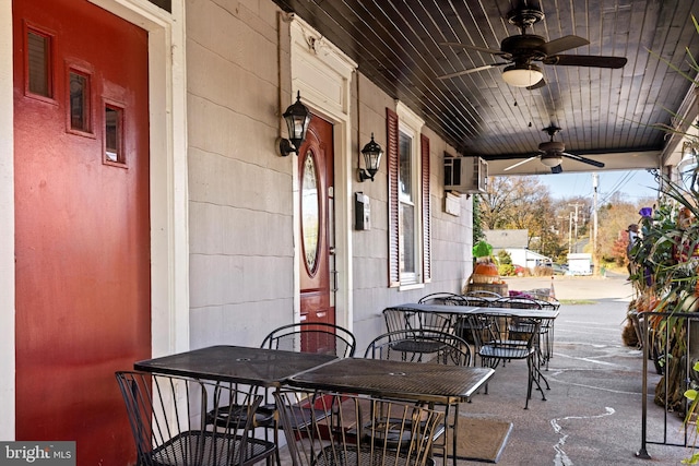 view of patio / terrace with a wall mounted AC, covered porch, and ceiling fan