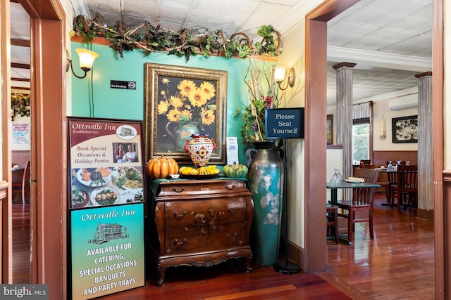 interior space with dark hardwood / wood-style flooring, crown molding, and a wall mounted AC