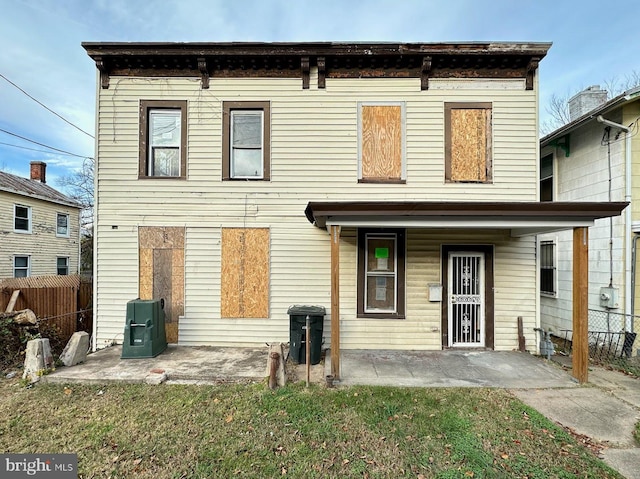 rear view of house featuring a patio area and a yard