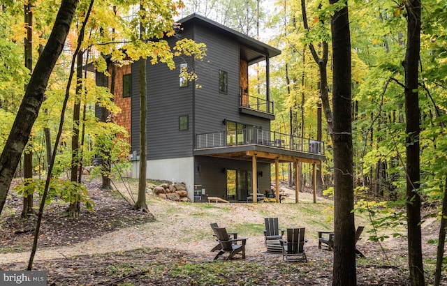 back of property featuring a balcony