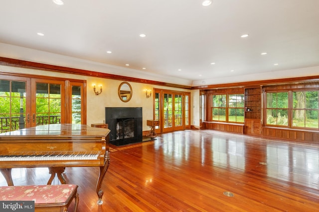 unfurnished living room featuring french doors and light wood-type flooring