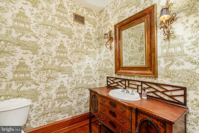 bathroom featuring hardwood / wood-style flooring, vanity, and toilet