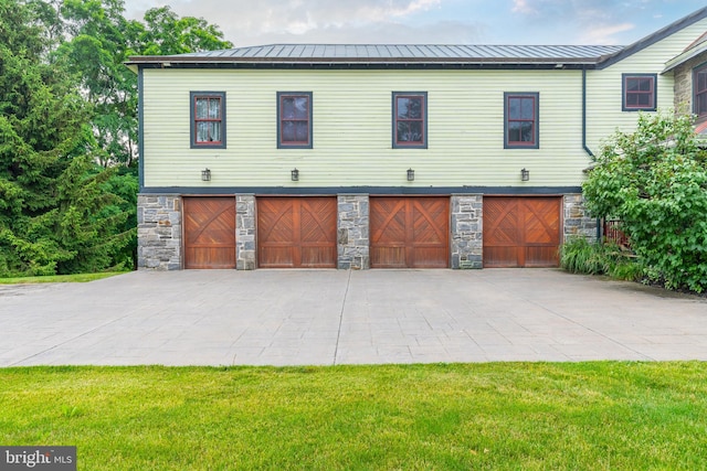 view of front of property with a front lawn and a garage