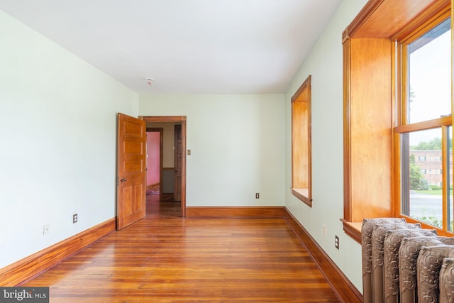 empty room featuring dark hardwood / wood-style flooring