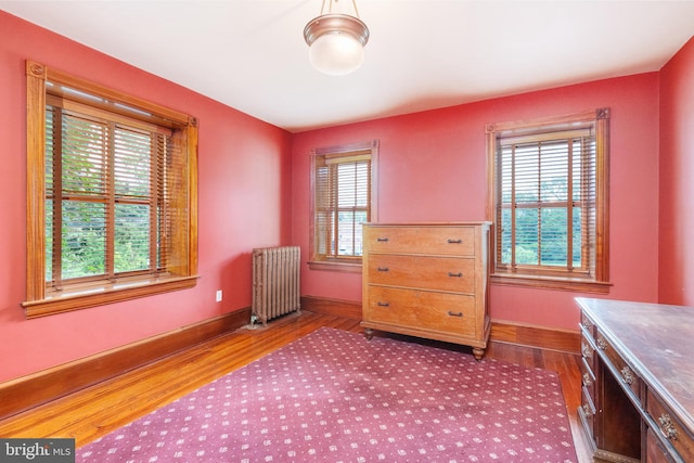 interior space with radiator heating unit and hardwood / wood-style flooring