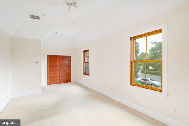 carpeted empty room featuring lofted ceiling and ceiling fan