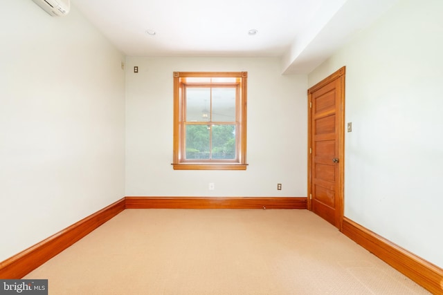 carpeted spare room with a wall mounted AC