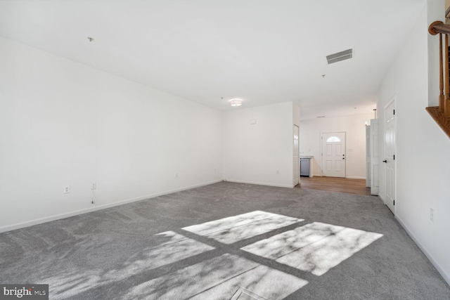 unfurnished room with light colored carpet