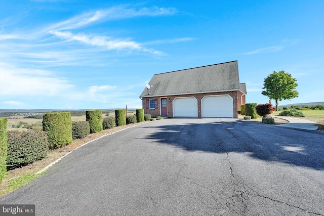 view of front of home featuring a rural view and a garage