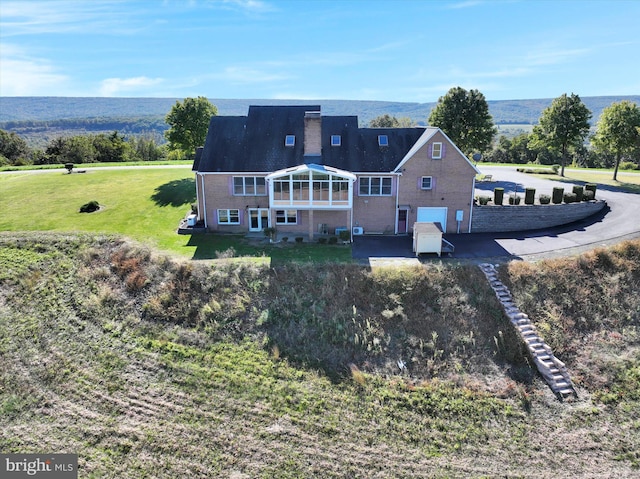 rear view of house with a yard