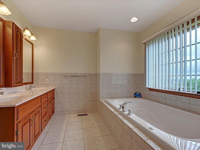 bathroom with dual sinks, tile flooring, tiled bath, and large vanity