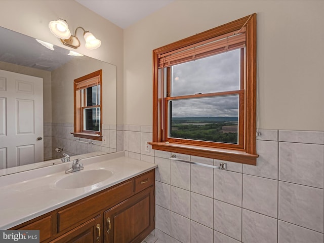 bathroom featuring vanity and tile walls