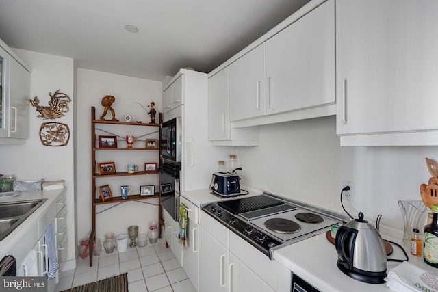 202 W Rittenhouse Sq Unit 1105, Philadelphia, PA 19103 - kitchen featuring black oven, stovetop with downdraft, white cabinetry, and light countertops
