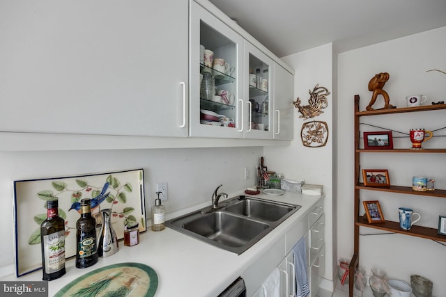 202 W Rittenhouse Sq Unit 1105, Philadelphia, PA 19103 - kitchen with light countertops, white cabinets, a sink, and glass insert cabinets