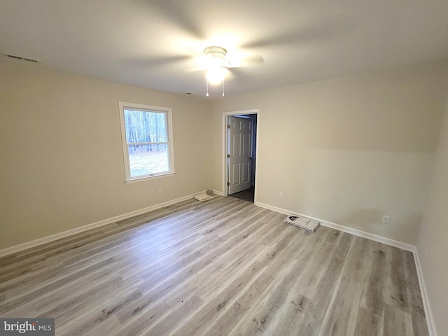 unfurnished room featuring light wood-type flooring and ceiling fan