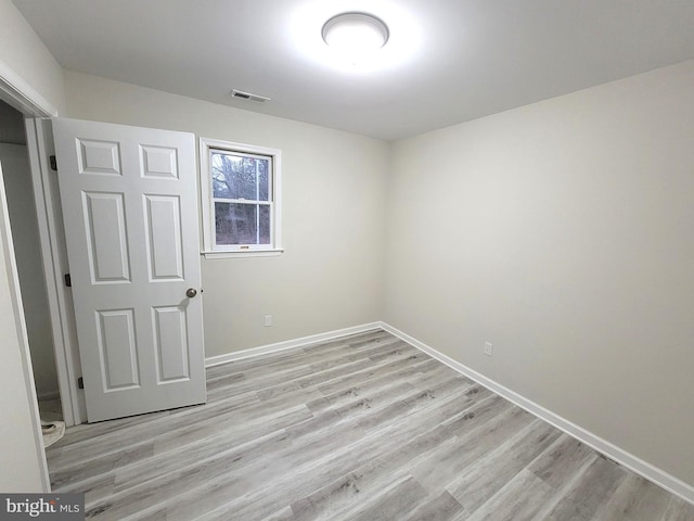 unfurnished room with light wood-type flooring