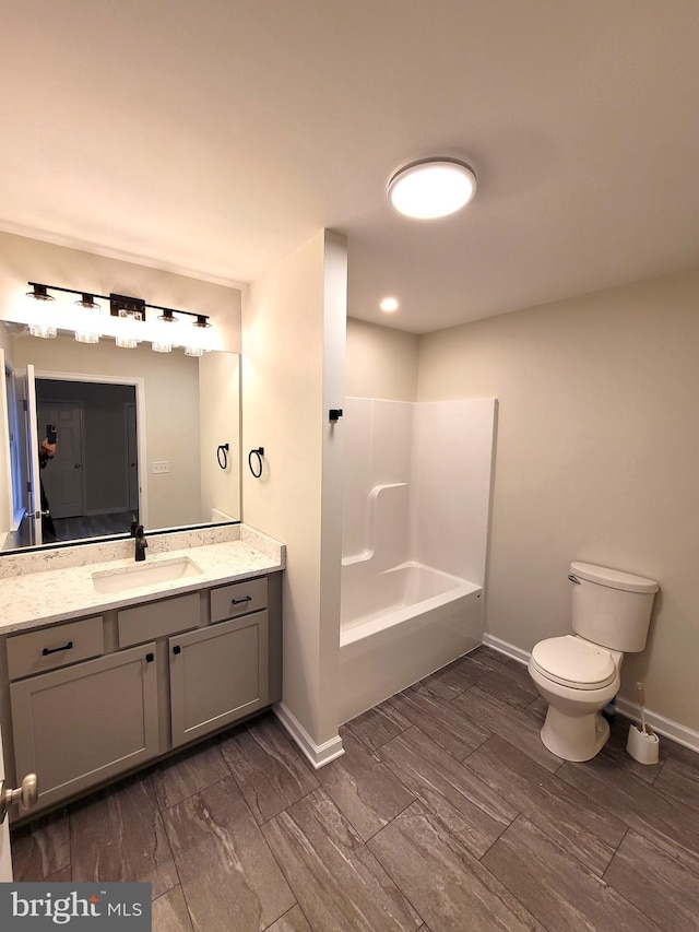 bathroom featuring vanity, wood-type flooring, and toilet