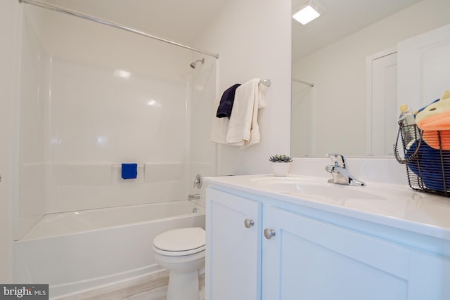 full bathroom featuring toilet, large vanity, shower / bathing tub combination, and hardwood / wood-style flooring