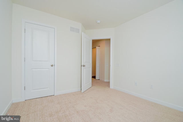 unfurnished bedroom featuring light colored carpet