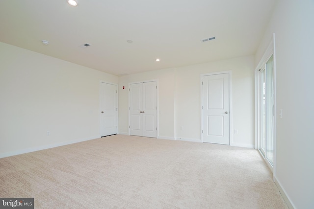 empty room featuring light carpet