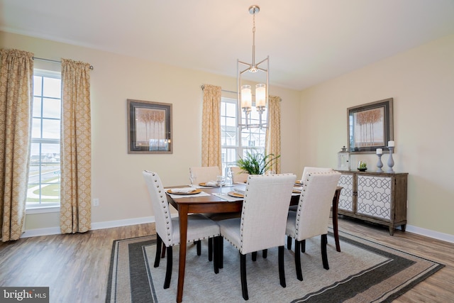 dining area with a chandelier and light hardwood / wood-style floors