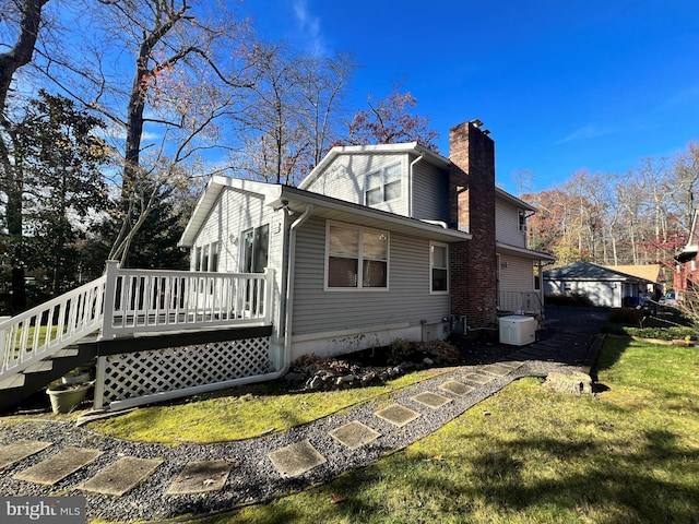 view of home's exterior featuring a lawn and a wooden deck