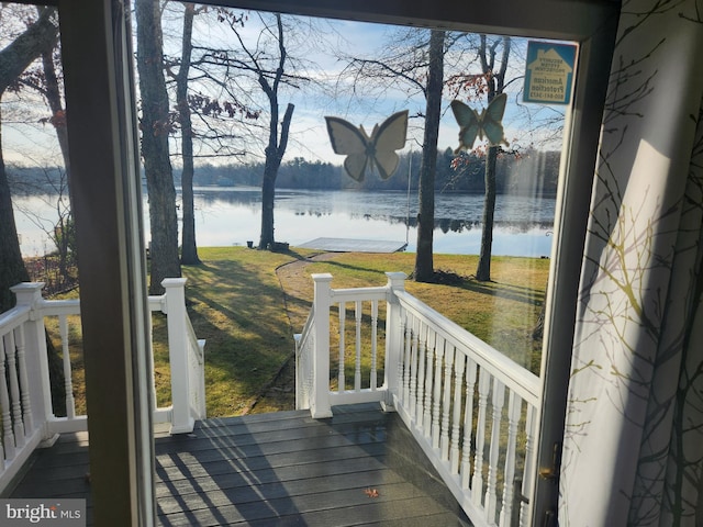 deck featuring a water view and a yard