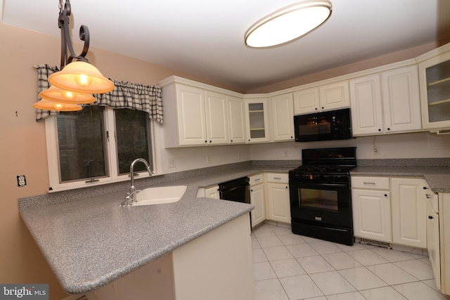 kitchen with sink, hanging light fixtures, kitchen peninsula, white cabinets, and black appliances