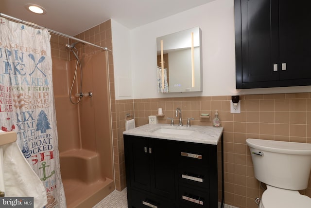 bathroom featuring a shower with curtain, vanity, tile walls, and toilet