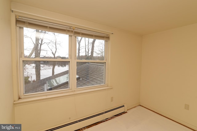 unfurnished room featuring a water view and a baseboard heating unit