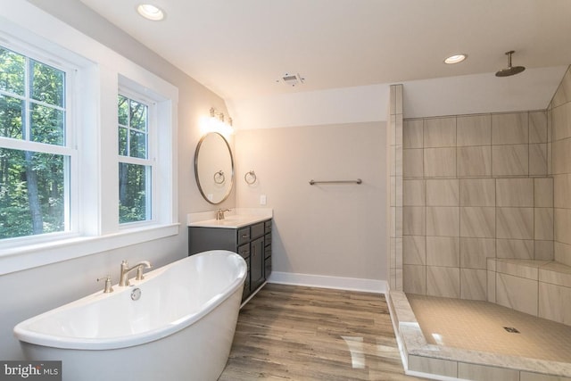 bathroom with vanity, a healthy amount of sunlight, shower with separate bathtub, and hardwood / wood-style flooring