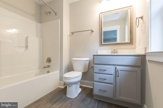 full bathroom featuring vanity, toilet, wood-type flooring, and bathtub / shower combination