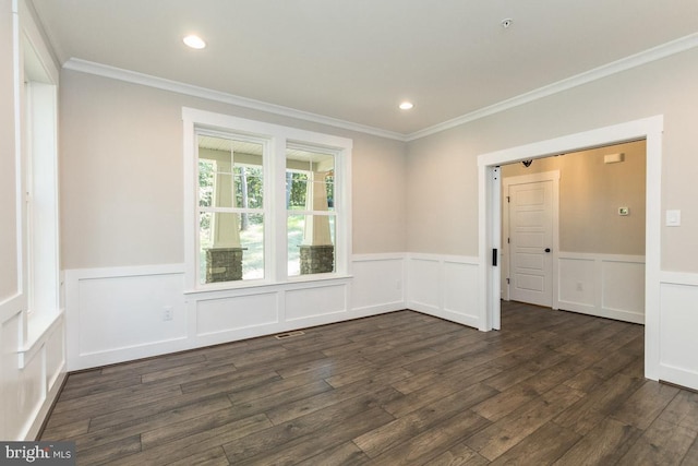 empty room with dark hardwood / wood-style flooring and crown molding