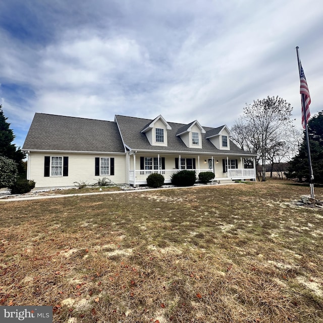 cape cod-style house with covered porch and a front lawn