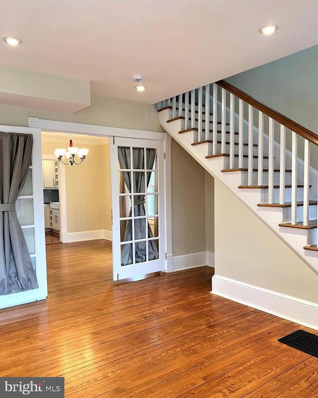8067 Croom Rd, Upper Marlboro, MD 20772 - staircase with baseboards, hardwood / wood-style floors, a chandelier, and recessed lighting