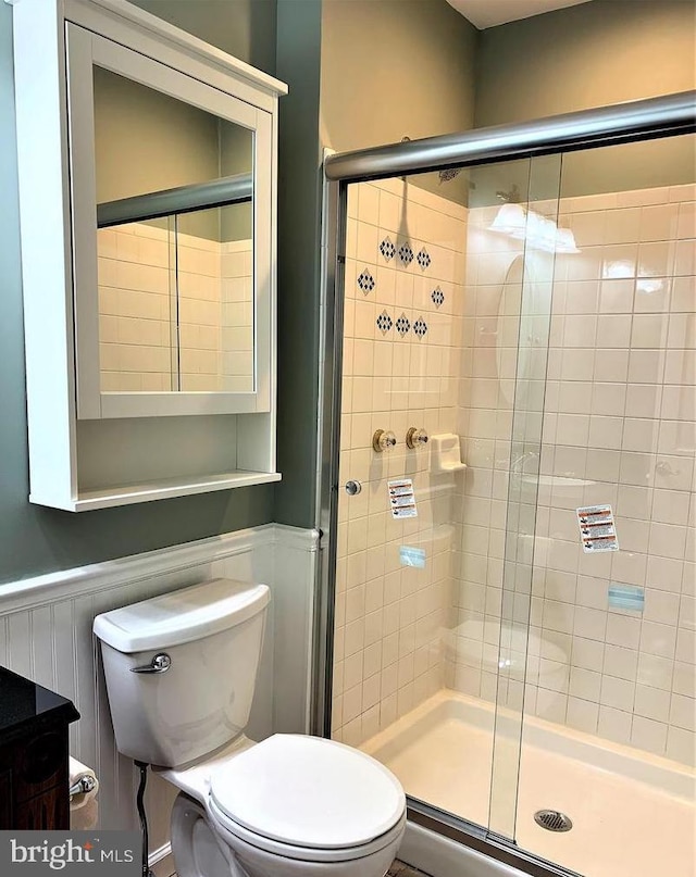 8067 Croom Rd, Upper Marlboro, MD 20772 - full bathroom with a stall shower, a wainscoted wall, and toilet