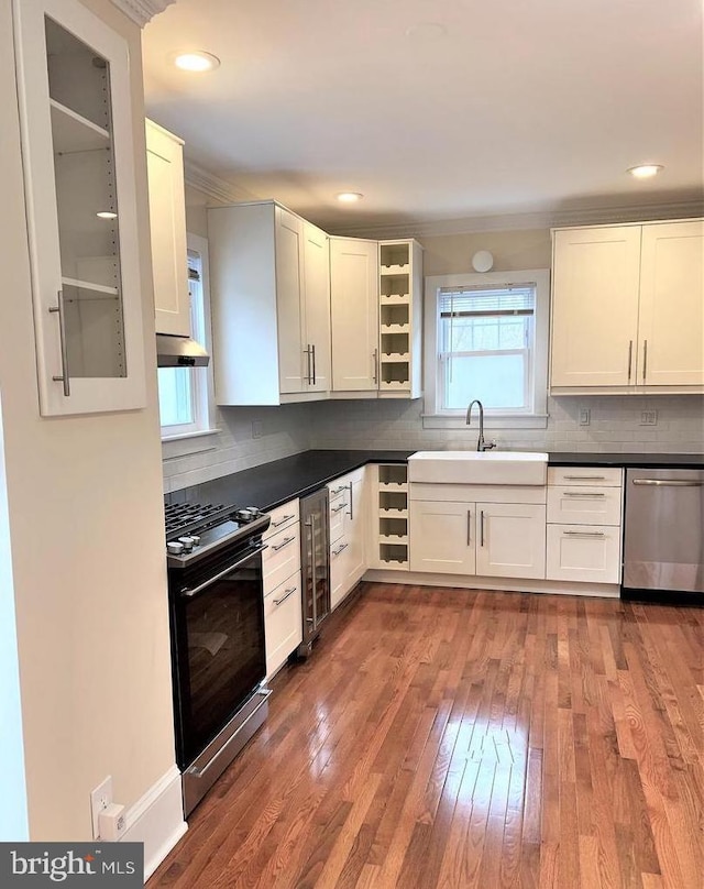 8067 Croom Rd, Upper Marlboro, MD 20772 - kitchen featuring stainless steel dishwasher, gas range, a sink, wine cooler, and hardwood / wood-style flooring