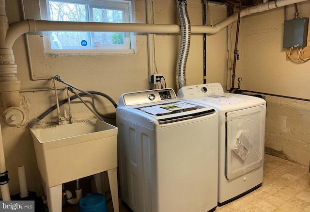 8067 Croom Rd, Upper Marlboro, MD 20772 - washroom with washer and clothes dryer, electric panel, and light flooring