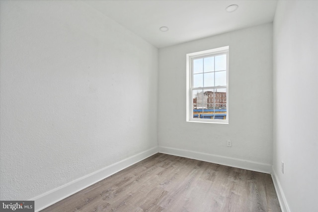 unfurnished room with light hardwood / wood-style floors