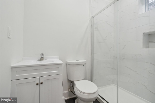 bathroom featuring toilet, an enclosed shower, and vanity