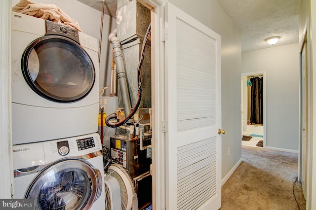 laundry area with light carpet, stacked washer and dryer, and a textured ceiling